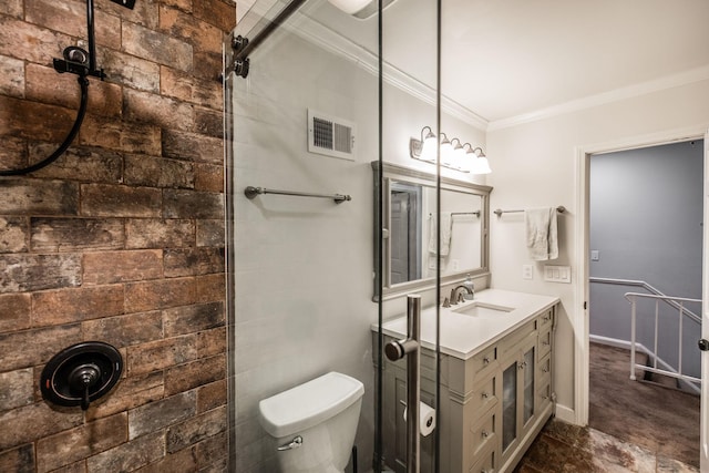 bathroom featuring crown molding, toilet, a tile shower, vanity, and baseboards