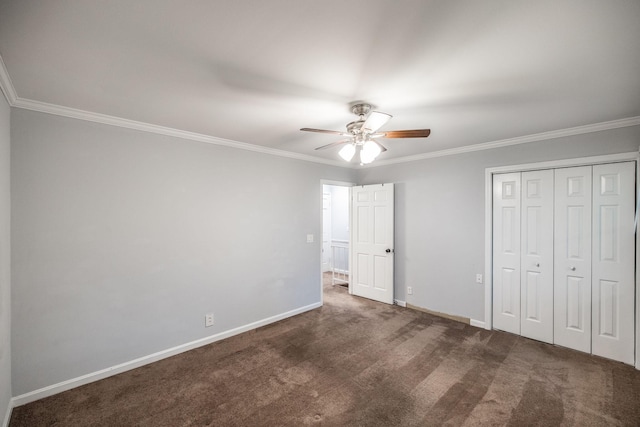unfurnished bedroom with ornamental molding, carpet, baseboards, a closet, and a ceiling fan