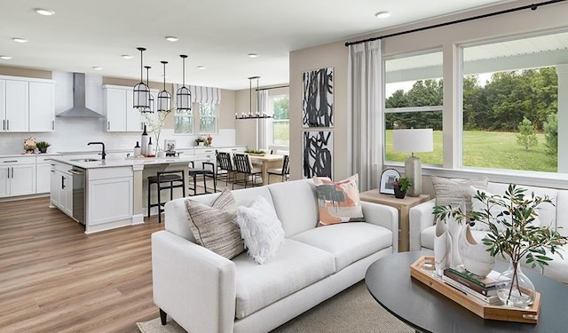living room with recessed lighting, a wealth of natural light, and light wood-type flooring