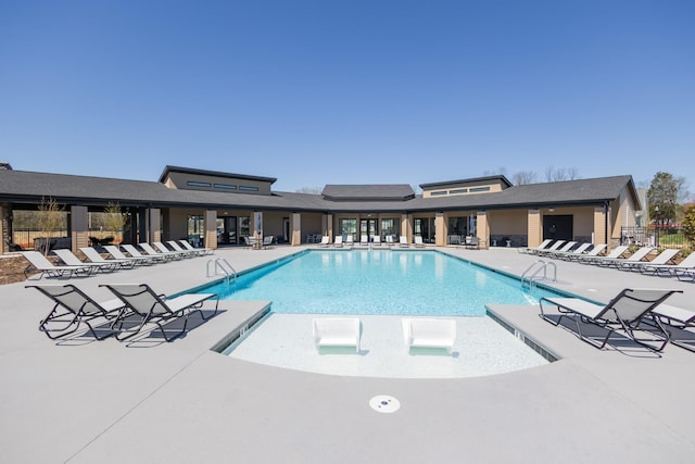 community pool featuring a patio and fence