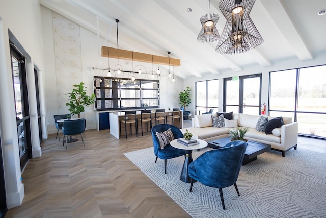 living area featuring an inviting chandelier, baseboards, high vaulted ceiling, and beam ceiling