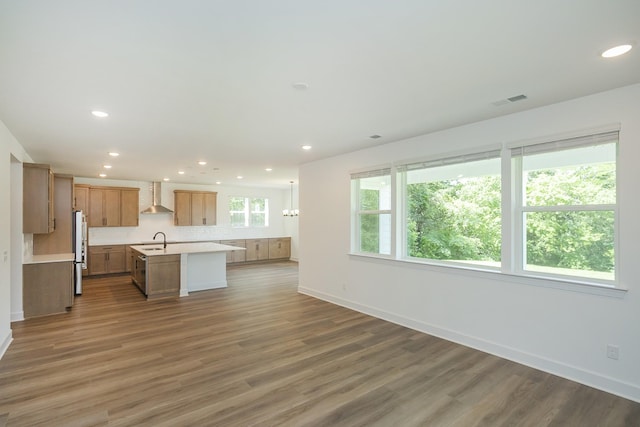 138 W Cassa Way, Mount Juliet, TN 37122 - kitchen with wall chimney range hood, freestanding refrigerator, a sink, open floor plan, and light countertops