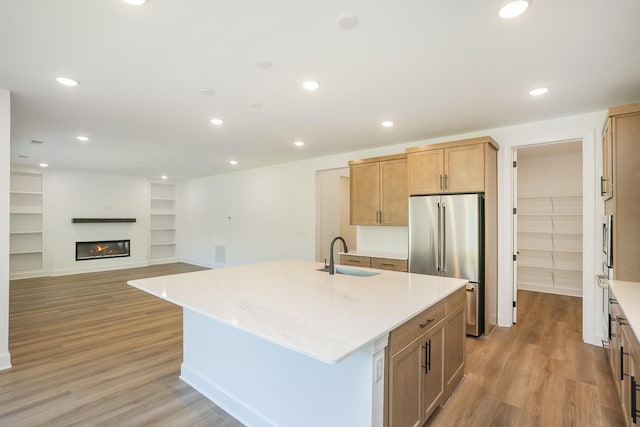 138 W Cassa Way, Mount Juliet, TN 37122 - kitchen with high end refrigerator, a sink, light wood-style floors, an island with sink, and light stone counters