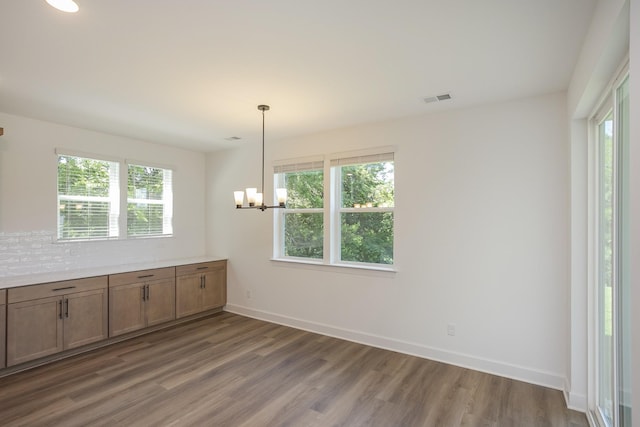 138 W Cassa Way, Mount Juliet, TN 37122 - unfurnished dining area featuring wood finished floors, a chandelier, and baseboards