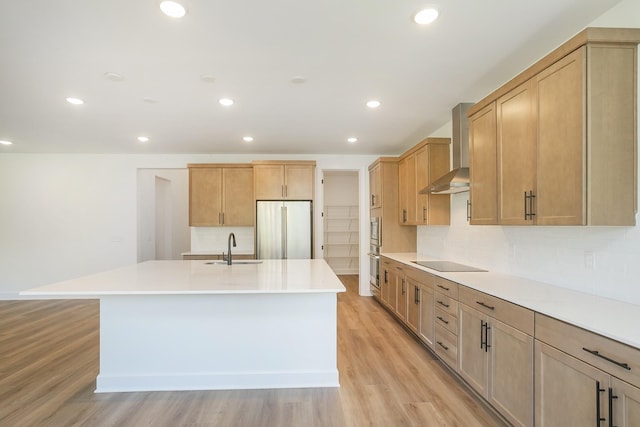 138 W Cassa Way, Mount Juliet, TN 37122 - kitchen featuring wall chimney range hood, freestanding refrigerator, black electric cooktop, a sink, and an island with sink
