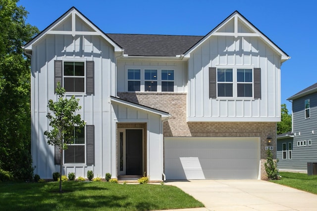 138 W Cassa Way, Mount Juliet, TN 37122 - view of front facade with board and batten siding, an attached garage, concrete driveway, and a front lawn