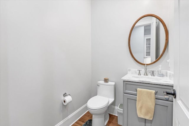 1520 Raulston Falls Rd, Jasper, TN 37347 - half bathroom featuring vanity, toilet, baseboards, and wood finished floors