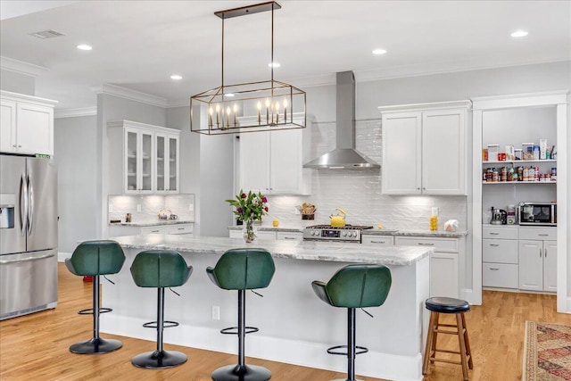 1520 Raulston Falls Rd, Jasper, TN 37347 - kitchen featuring wall chimney exhaust hood, crown molding, white cabinetry, backsplash, and appliances with stainless steel finishes