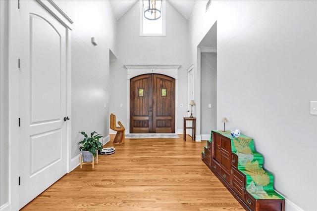 1520 Raulston Falls Rd, Jasper, TN 37347 - entrance foyer with baseboards, light wood-type flooring, and high vaulted ceiling