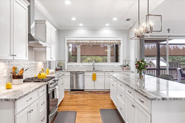 1520 Raulston Falls Rd, Jasper, TN 37347 - kitchen with a sink, a healthy amount of sunlight, wall chimney range hood, appliances with stainless steel finishes, and ornamental molding