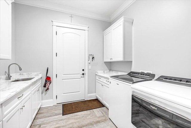1520 Raulston Falls Rd, Jasper, TN 37347 - laundry area featuring light wood finished floors, a sink, crown molding, washing machine and clothes dryer, and cabinet space