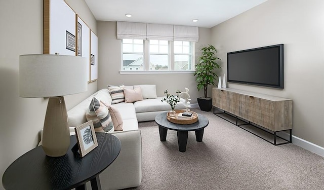 carpeted living area featuring baseboards and recessed lighting