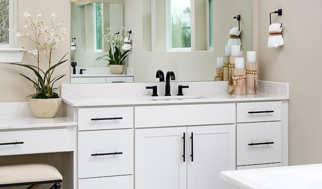 bathroom with vanity and plenty of natural light