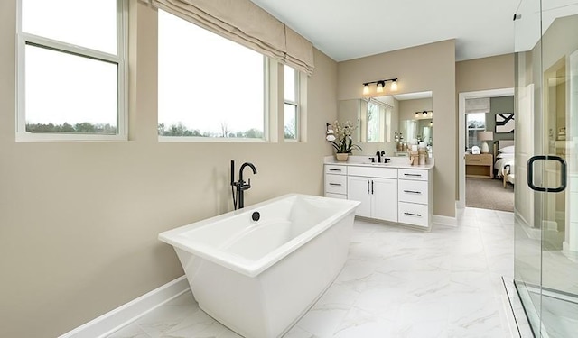 full bathroom with ensuite bathroom, marble finish floor, vanity, a shower stall, and baseboards