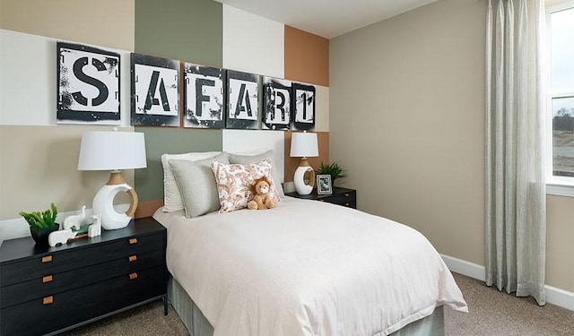 carpeted bedroom with baseboards and multiple windows