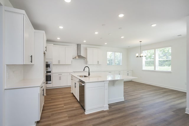 135 W Cassa Way, Mount Juliet, TN 37122 - kitchen featuring stainless steel appliances, wall chimney exhaust hood, a sink, backsplash, and recessed lighting