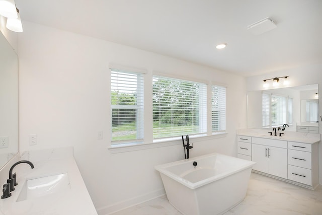 135 W Cassa Way, Mount Juliet, TN 37122 - full bath featuring healthy amount of natural light, a soaking tub, two vanities, marble look tiles, and recessed lighting