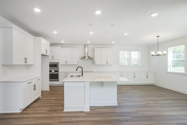 135 W Cassa Way, Mount Juliet, TN 37122 - kitchen with wall chimney exhaust hood, a sink, a chandelier, tasteful backsplash, and recessed lighting