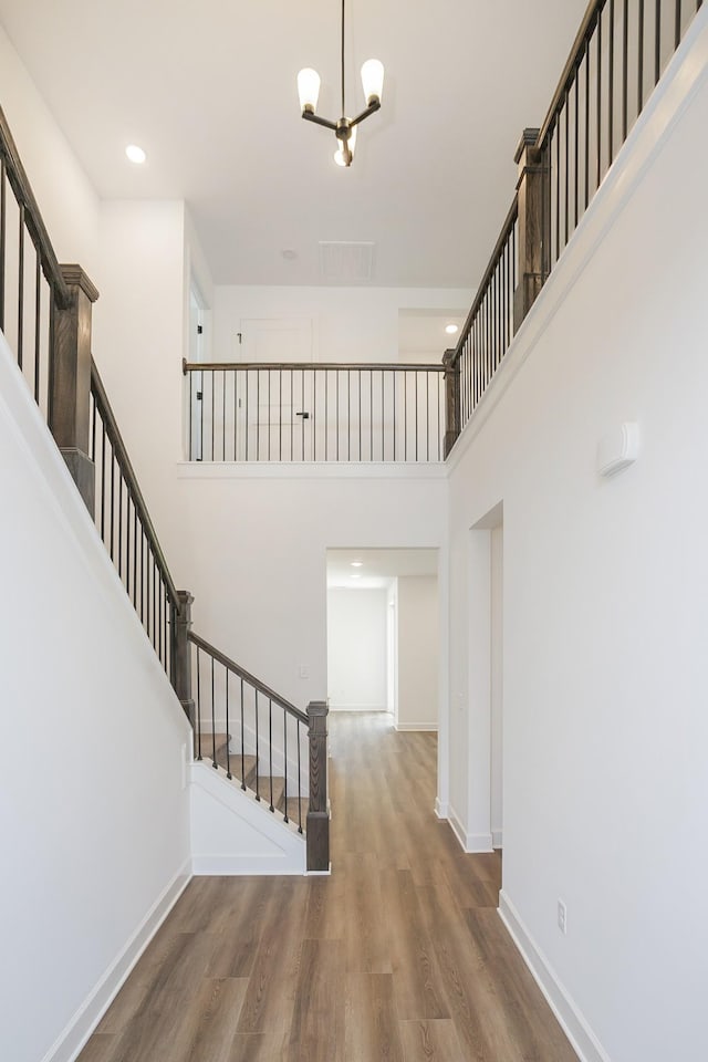 135 W Cassa Way, Mount Juliet, TN 37122 - foyer featuring stairs, a high ceiling, wood finished floors, a chandelier, and baseboards