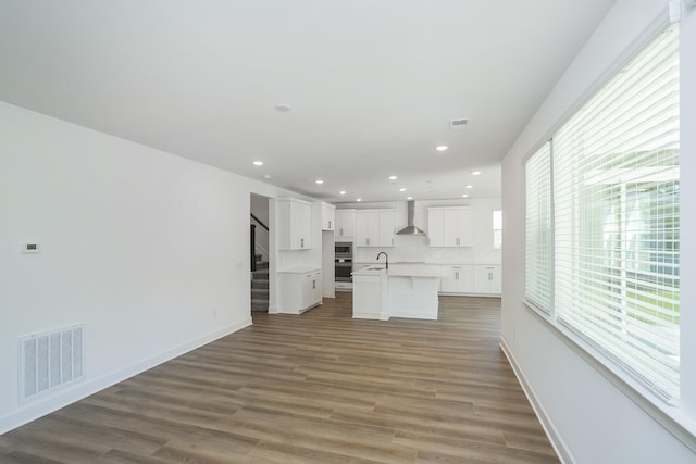 135 W Cassa Way, Mount Juliet, TN 37122 - unfurnished living room with a sink, stairs, wood finished floors, recessed lighting, and baseboards