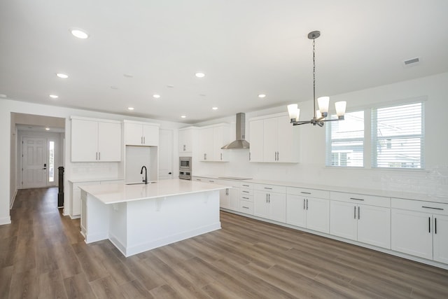 135 W Cassa Way, Mount Juliet, TN 37122 - kitchen featuring wall chimney exhaust hood, stainless steel appliances, wood finished floors, white cabinets, and recessed lighting