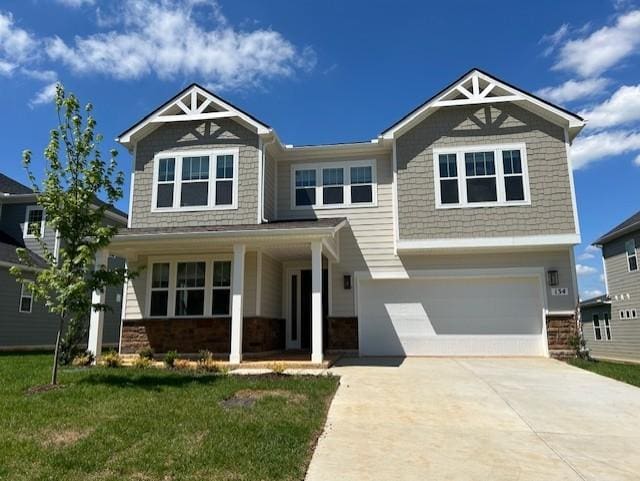 136 W Cassa Way, Mount Juliet, TN 37122 - craftsman inspired home featuring covered porch, a garage, driveway, a front lawn, and stone siding