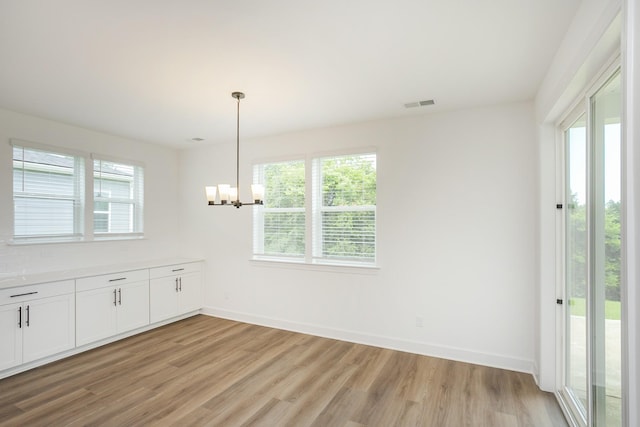 136 W Cassa Way, Mount Juliet, TN 37122 - unfurnished dining area featuring healthy amount of natural light, a chandelier, and light wood-type flooring