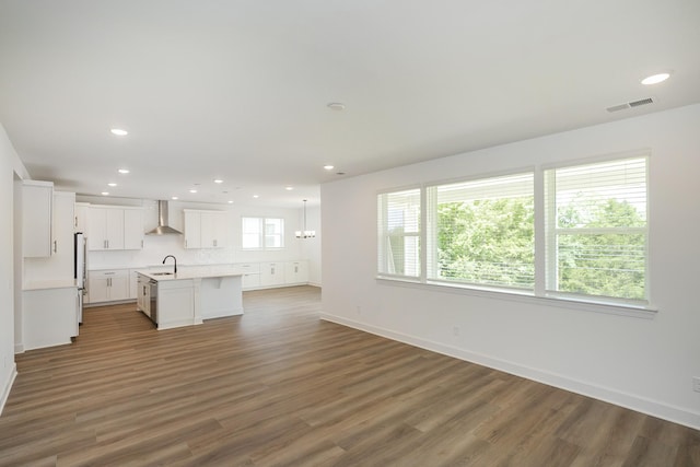 136 W Cassa Way, Mount Juliet, TN 37122 - unfurnished living room featuring recessed lighting, wood finished floors, baseboards, and a sink