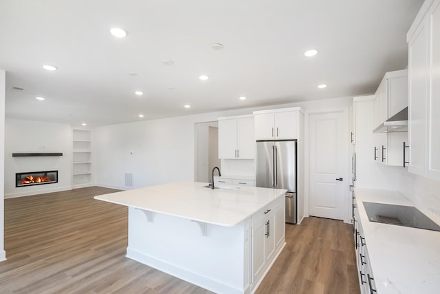 136 W Cassa Way, Mount Juliet, TN 37122 - kitchen with high quality fridge, exhaust hood, light wood-style flooring, a sink, and a center island with sink