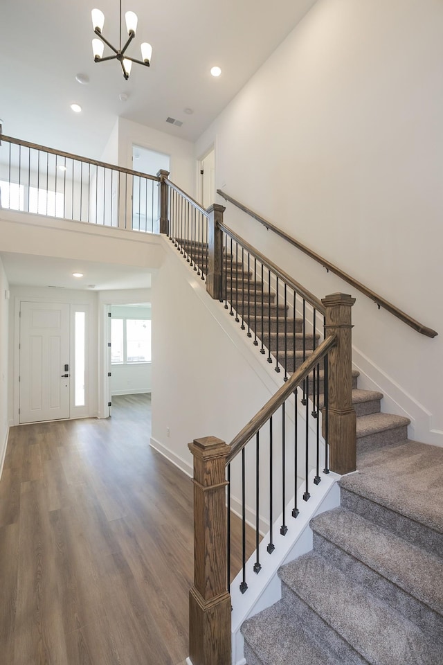 136 W Cassa Way, Mount Juliet, TN 37122 - staircase featuring a chandelier, wood finished floors, recessed lighting, a towering ceiling, and baseboards