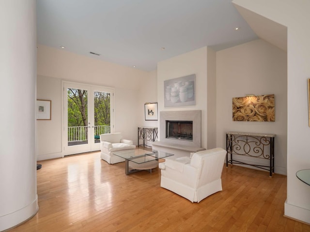1229 Vintage Pl, Nashville, TN 37215 - living room with french doors, light wood-type flooring, and a fireplace with raised hearth