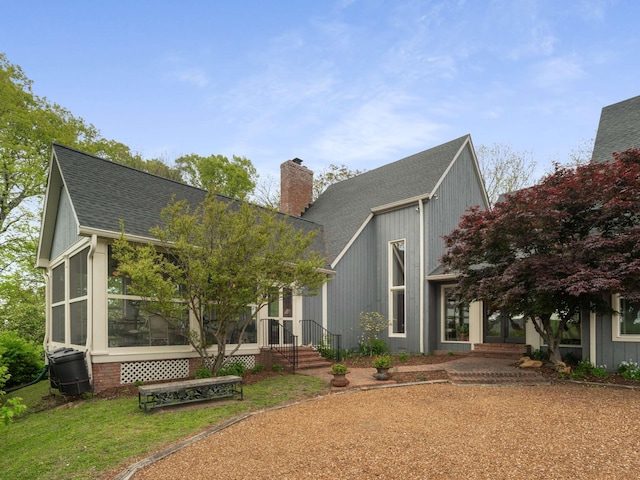 1229 Vintage Pl, Nashville, TN 37215 - view of front of house featuring a chimney, a shingled roof, and a sunroom