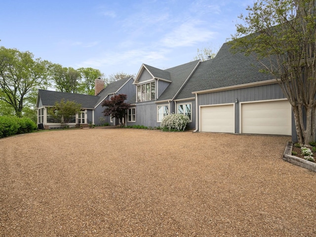 1229 Vintage Pl, Nashville, TN 37215 - view of front facade featuring an attached garage, a chimney, driveway, and a shingled roof