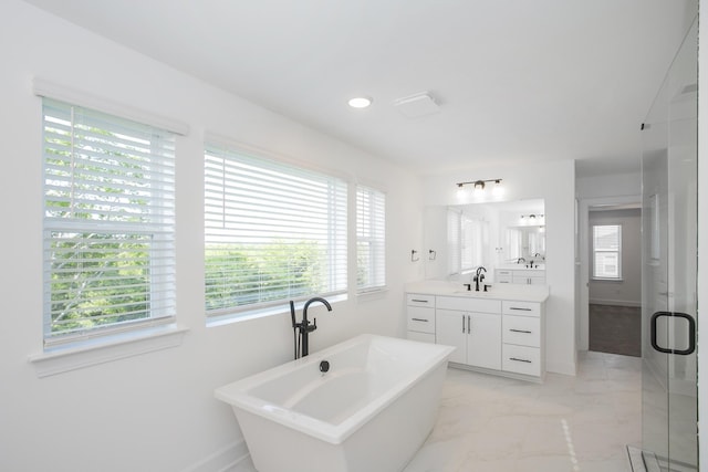 full bathroom featuring marble finish floor, vanity, a stall shower, a soaking tub, and baseboards
