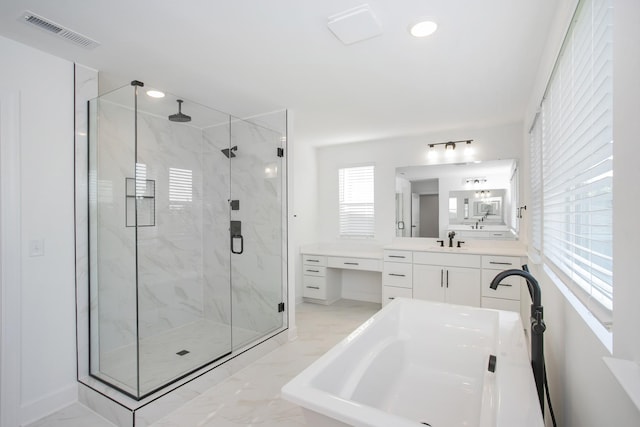 full bath with a marble finish shower, visible vents, a freestanding tub, marble finish floor, and vanity