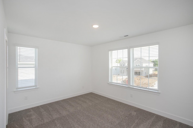 unfurnished room featuring carpet, baseboards, and plenty of natural light