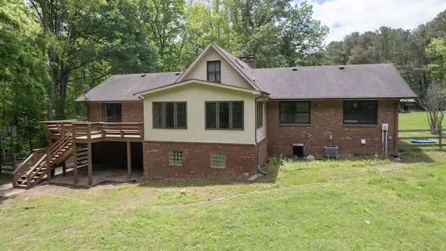 7621 Fernvale Rd, Fairview, TN 37062 - back of property with brick siding, a wooden deck, stairway, a yard, and central AC unit