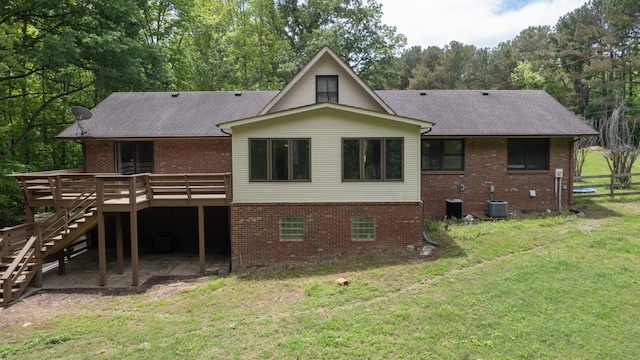 7621 Fernvale Rd, Fairview, TN 37062 - back of property with brick siding, a wooden deck, central AC unit, and a shingled roof