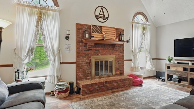 7621 Fernvale Rd, Fairview, TN 37062 - living room featuring wood finished floors, high vaulted ceiling, a fireplace, and baseboards
