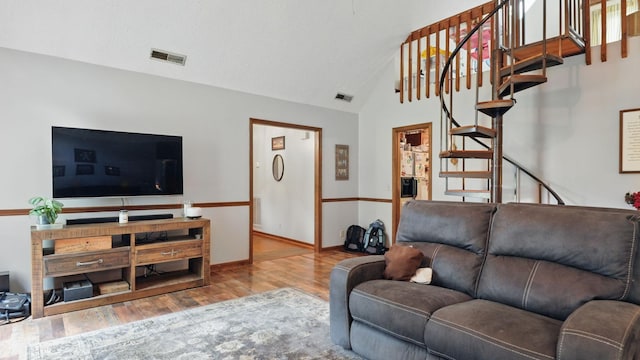 7621 Fernvale Rd, Fairview, TN 37062 - living room featuring wood finished floors, stairway, vaulted ceiling, and baseboards