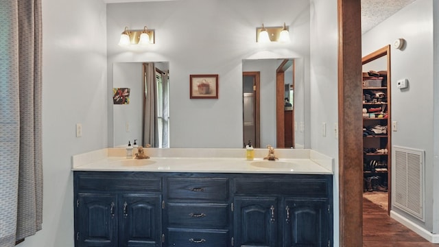 7621 Fernvale Rd, Fairview, TN 37062 - bathroom with double vanity, wood finished floors, and a spacious closet