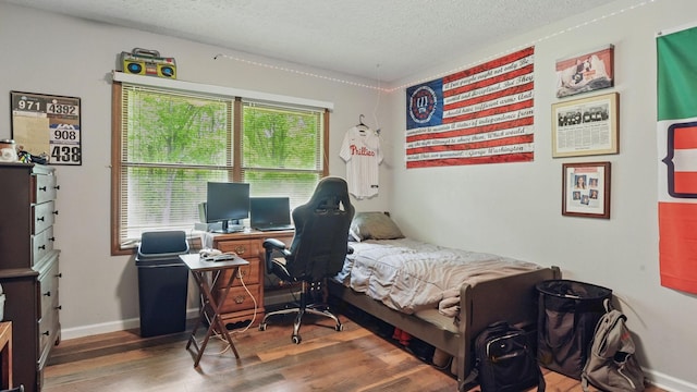 7621 Fernvale Rd, Fairview, TN 37062 - bedroom featuring wood finished floors, a textured ceiling, and baseboards