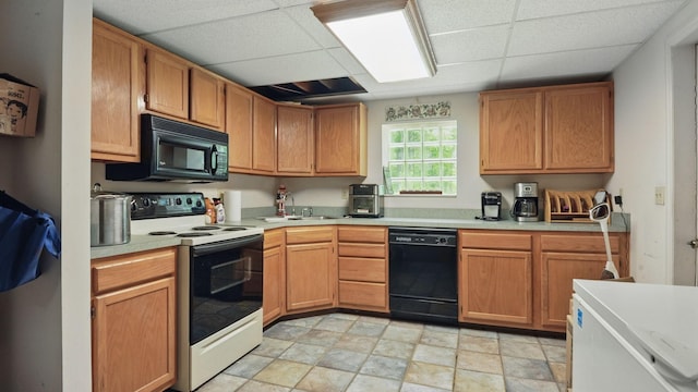 7621 Fernvale Rd, Fairview, TN 37062 - kitchen with black appliances, a drop ceiling, light countertops, light stone finish flooring, and a sink