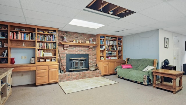 7621 Fernvale Rd, Fairview, TN 37062 - living area featuring a wood stove, a paneled ceiling, built in features, and light colored carpet