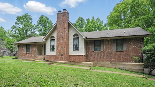 7621 Fernvale Rd, Fairview, TN 37062 - view of front of house featuring a chimney, a front yard, brick siding, and a shingled roof