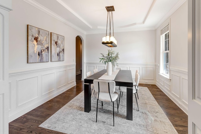 2078 Autumn Ridge Way, Spring Hill, TN 37174 - dining room featuring arched walkways, a raised ceiling, dark wood-type flooring, a decorative wall, and a wainscoted wall