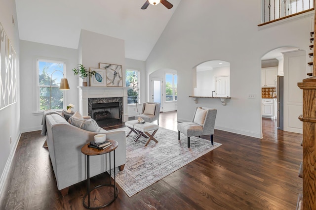 2078 Autumn Ridge Way, Spring Hill, TN 37174 - living room featuring a ceiling fan, dark wood finished floors, high vaulted ceiling, a high end fireplace, and baseboards