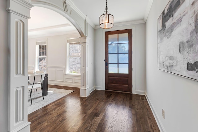2078 Autumn Ridge Way, Spring Hill, TN 37174 - entrance foyer featuring arched walkways, dark wood-type flooring, crown molding, decorative columns, and a wainscoted wall