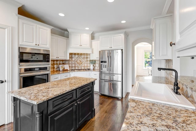 2078 Autumn Ridge Way, Spring Hill, TN 37174 - kitchen featuring stainless steel appliances, dark cabinets, a sink, white cabinets, and crown molding