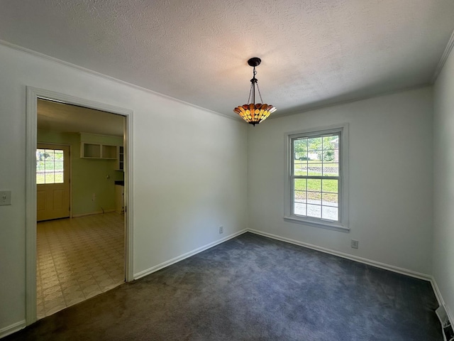 spare room with a textured ceiling, baseboards, and dark carpet